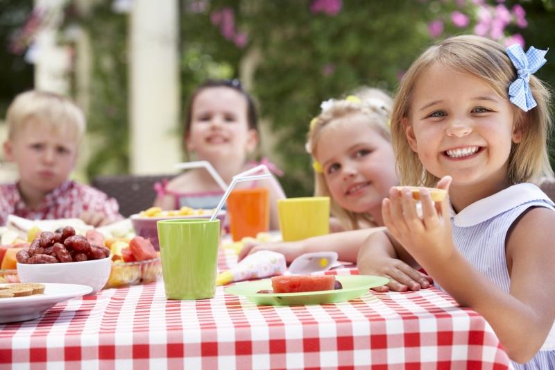 4657761-group-of-children-enjoying-outdoor-tea-party